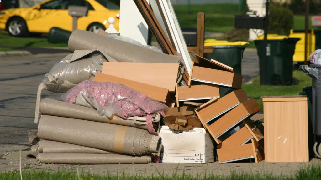 A pile of cardboard and other junk on the ground.