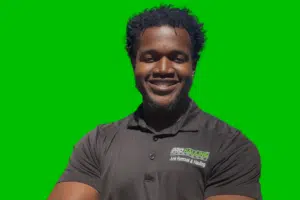 A man in black shirt smiling for the camera.