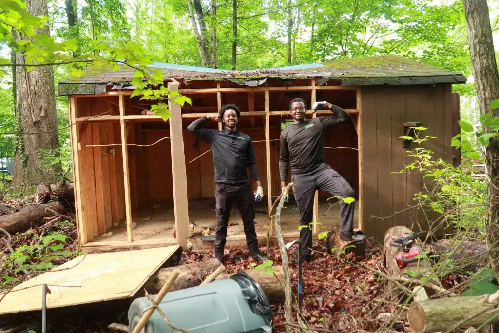 Shed removal and demolition – old wooden shed being dismantled and hauled away