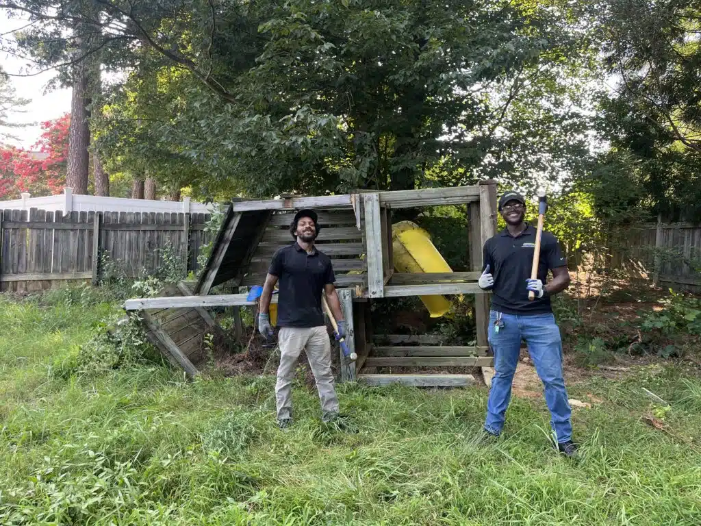 Pro Hauling crew performing playset removal in a backyard