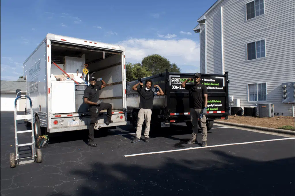 Junk removal team loading furniture into a truck